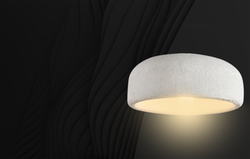 Pendant lights with geometric designs illuminating a modern open-concept living area